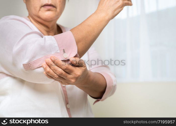 elbow pain old woman suffering from elbow pain at home, healthcare problem of senior concept