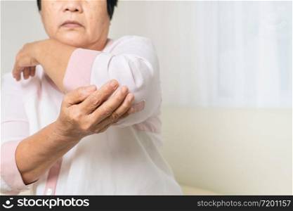elbow pain old woman suffering from elbow pain at home, healthcare problem of senior concept