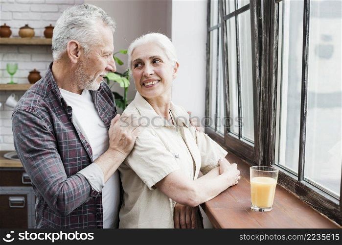 elder couple looking through window