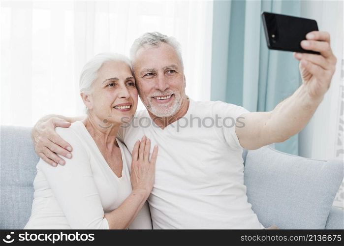 elder couple making selfie