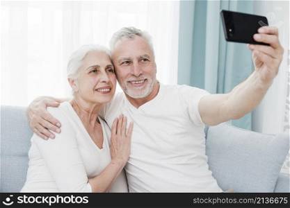 elder couple making selfie