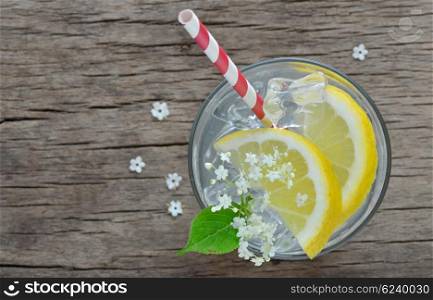 Elder lemonade with ice on old table wood