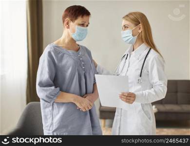 elder patient with medical mask covid recovery center female doctor