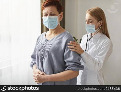 elder patient with medical mask covid recovery center female doctor with stethoscope