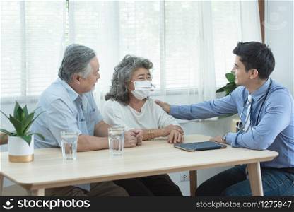 Elder senior old asian couple meeting specialist professional caucasian doctor visit at home consultant two retirement patient after checkup,health care and medical concept.