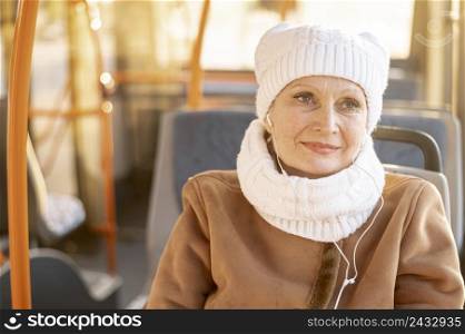 elder woman bus listening music