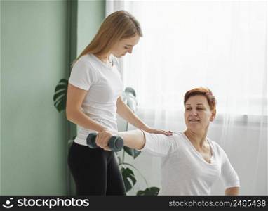 elder woman covid recovery doing physical exercises with dumbbell