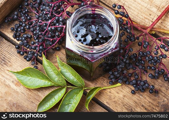 Elderberry jam and fresh berries.Homemade jam.Seasonal berries. Elderberry jam in a jar