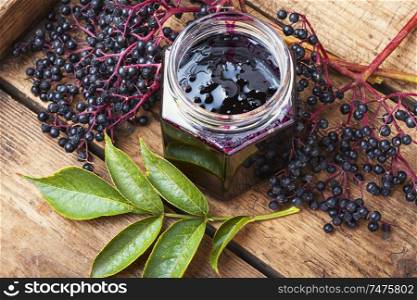 Elderberry jam and fresh berries.Homemade jam.Seasonal berries. Elderberry jam in a jar