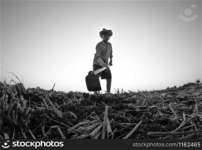 Elderly Asian farmers shoveling and prepare the soil with a spade for planting on sunset background.