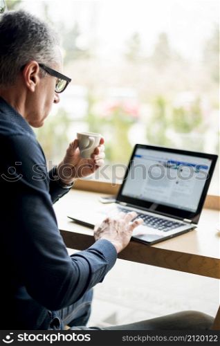 elderly businessman working laptop