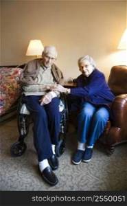 Elderly Caucasian couple in bedroom at retirement community center.