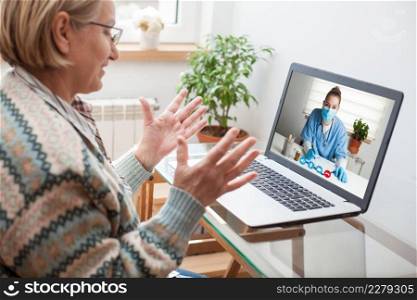 Elderly caucasian woman interacting with young female doctor via video call,medical worker seeing patient in a virtual house call,telemedicine during pandemic and on demand medical service concept 