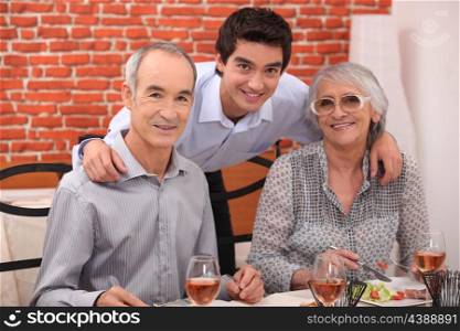 Elderly couple and grandson in restaurant