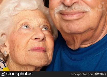 Elderly couple cheek by jowl