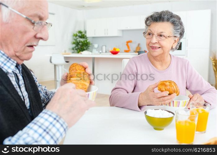 Elderly couple eating a Continental breakfast