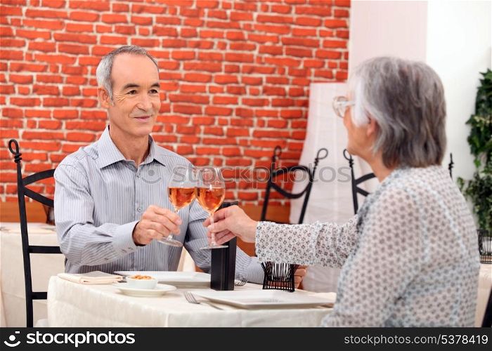 Elderly couple eating in restaurant