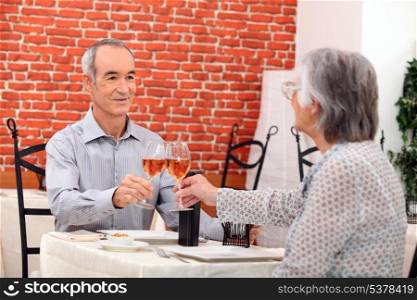 Elderly couple eating in restaurant