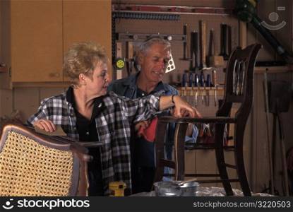 Elderly Couple Fixing Chair