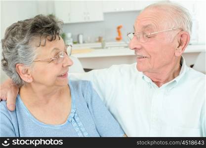 Elderly couple having a cuddle