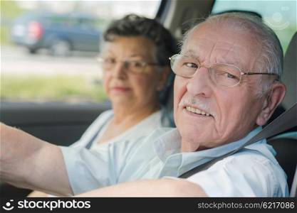 elderly couple in the car