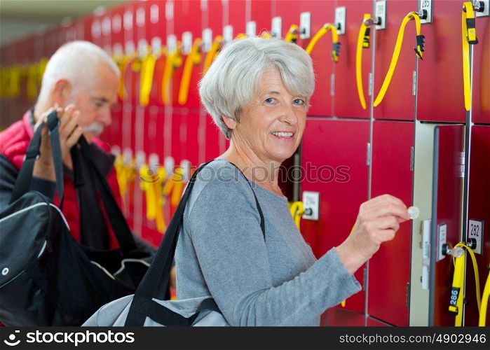 elderly couple in the locker room smiling