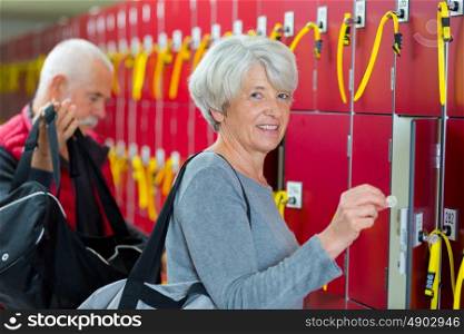 elderly couple in the locker room smiling
