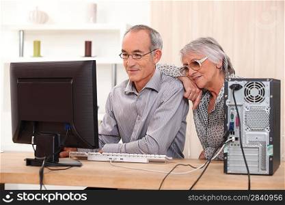 Elderly couple learning computer skills