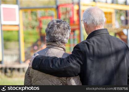elderly couple looking at a children&rsquo;s park