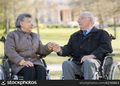 elderly couple on their wheelchair