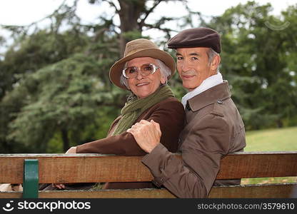 Elderly couple sat on bench