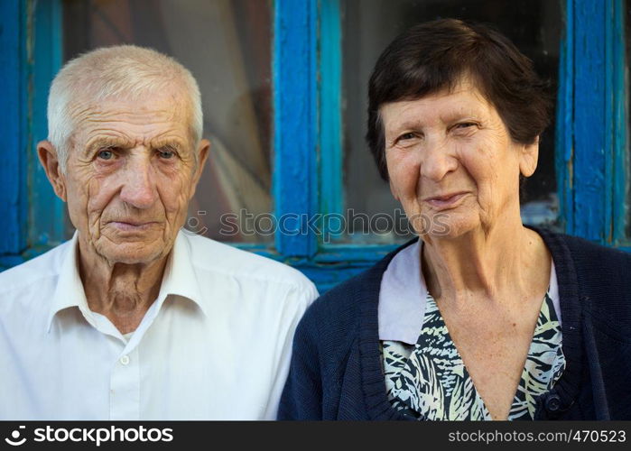 Elderly couple sitting at the front of rural house
