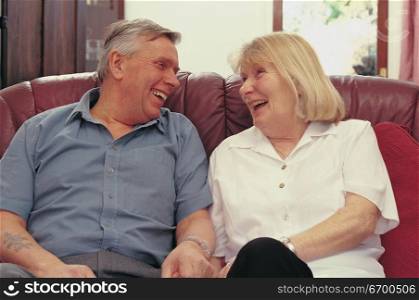 elderly couple sitting on a couch
