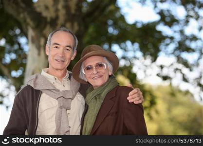 Elderly couple taking a walk together in the forest