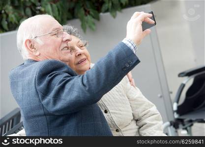 elderly couple taking selfie