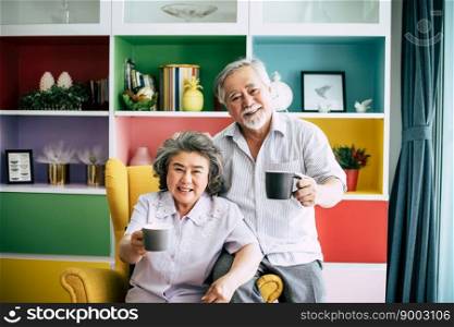 Elderly Couple Talking together and drinking coffee or milk