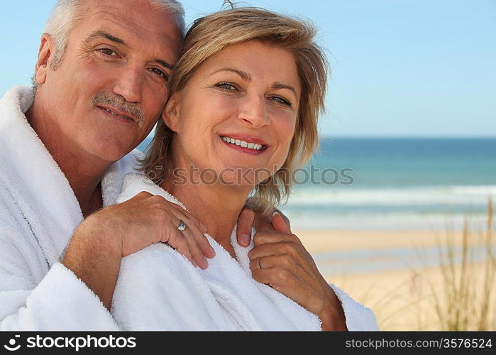 Elderly couple wearing white at the beach