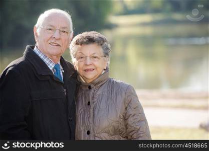 elderly couple with a lake in the background