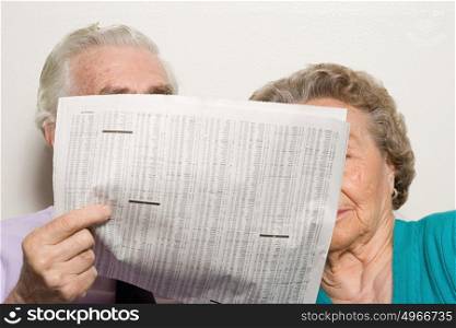 Elderly couple with newspaper