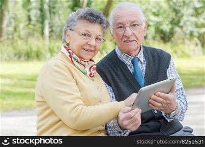 elderly couple with tablet