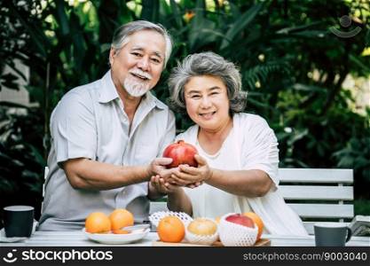 Elderly Couples Playing and eating some fruit