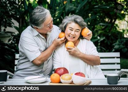 Elderly Couples Playing and eating some fruit