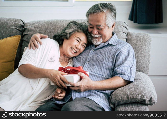 Elderly Couples Surprise and gift box at living room