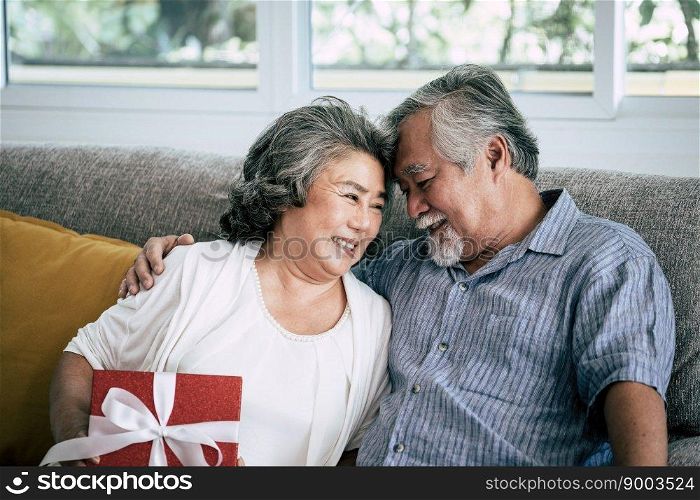 Elderly Couples Surprise and gift box at living room