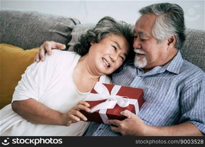 Elderly Couples Surprise and gift box at living room