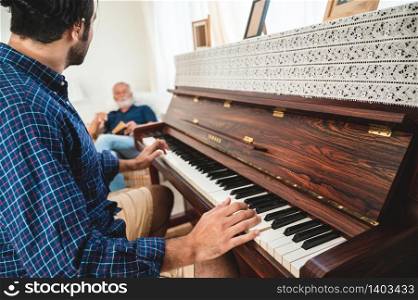 elderly dad and son are playing music at home, relax activity at home with family