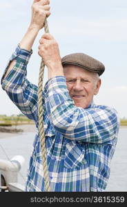 Elderly fisherman hauling rope