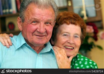 Elderly happy couple in a room
