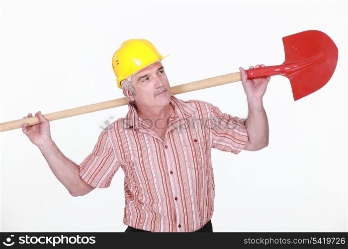 Elderly labourer holding a spade