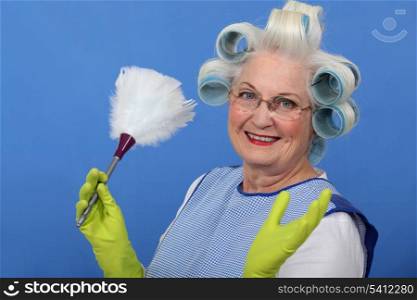 Elderly lady dusting